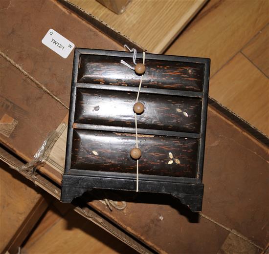 A miniature chest of drawers with German miniature cutlery, pans, wireless radio etc and a bamboo dolls dining set (poss POW)